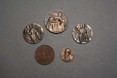 four coins are shown on a gray surface with a coin in the foreground
