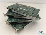 three computers are stacked on top of each other on a table