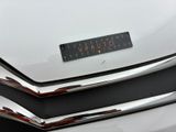 a close up of a car ' s emblem on the front of the car