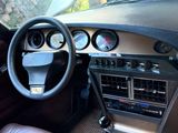 a car dashboard with a steering wheel and dashboard gauges
