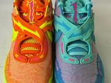 two pairs of children ' s running shoes on a white surface