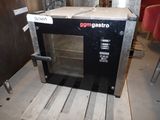 a black oven sitting on a pallet in a room