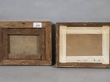 two framed paintings of a man and a woman on a gray background