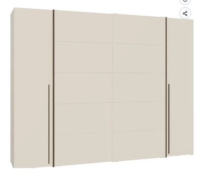 a white wardrobe with three doors and two drawers