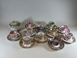 many cups and saucers sitting on a table