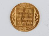 an image of a gold coin with a plaque on it