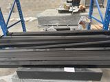 several pieces of metal are stacked on top of each other in a warehouse