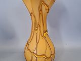 a yellow vase that is sitting on a table