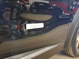 a close up of a car ' s door handle with a sticker on it