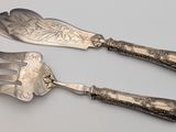 two forks and spoons that are sitting next to each other