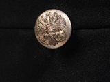 a close up of a button on a black jacket