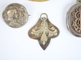 several different types of jewelry are displayed on a white surface