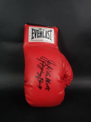 a close up of a red boxing glove on a black background