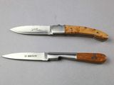 two knives that are sitting next to each other on a table
