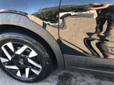 a reflection of a skateboarder on the side of a car