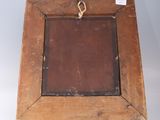 an old wooden picture frame with a metal handle on a white background