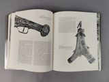 an open book with a drawing of a gun and a gun on it