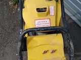 a yellow lawn mower that is sitting on the ground