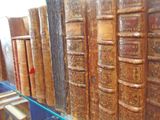 many old books on a shelf in a library