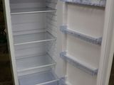 a white refrigerator with its door open on the floor