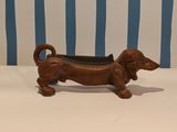 a small brown dog shaped planter on a table