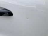 a close up of a door handle on a white car
