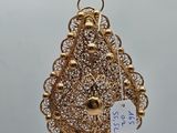 a close up of a pair of earrings hanging from a wooden stick