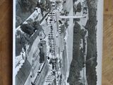 a black and white photo of a train going down the tracks