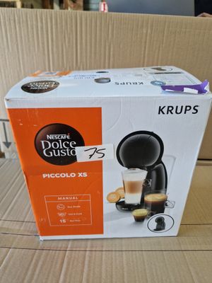 packaging of a coffee machine sitting on top of a cardboard box
