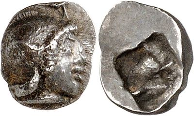 a close up of a coin with a face on it