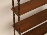 an image of a wooden shelf with three shelves on top of it