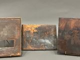 three old books sitting on top of a table next to each other