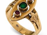 an image of a gold ring with green and red stones