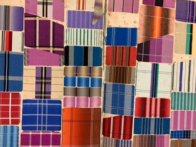 a lot of different colors of fabric on the wall