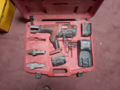a red tool case with tools in it on the floor