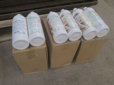 plusieurs flacons de lotion posés sur une boîte en carton