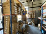 many boxes on the shelves in the warehouse