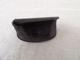a small black purse sitting on a white surface