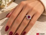 woman ' s hand with red manicured nails and a diamond ring