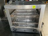 an image of a stainless steel oven with three trays of food in it