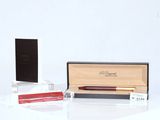 two pens and a box on a white surface