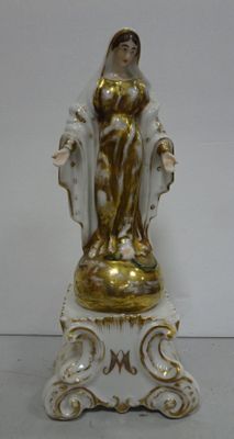 a figurine of a woman sitting on top of a table