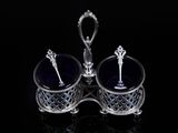 pair of silver and blue glass dishes with spoons on a black surface