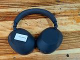 an image of a pair of headphones sitting on top of a wooden table