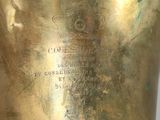 a close up of a gold vase on a table
