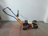 a small lawn mower that is sitting on the floor