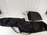a black umbrella and a black bag on a white table