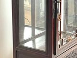 a display case with a glass door on top of it