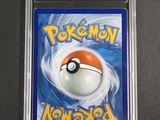 a close up of a pokemon card in a plastic case