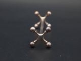 a close up of a silver ring on a black surface
